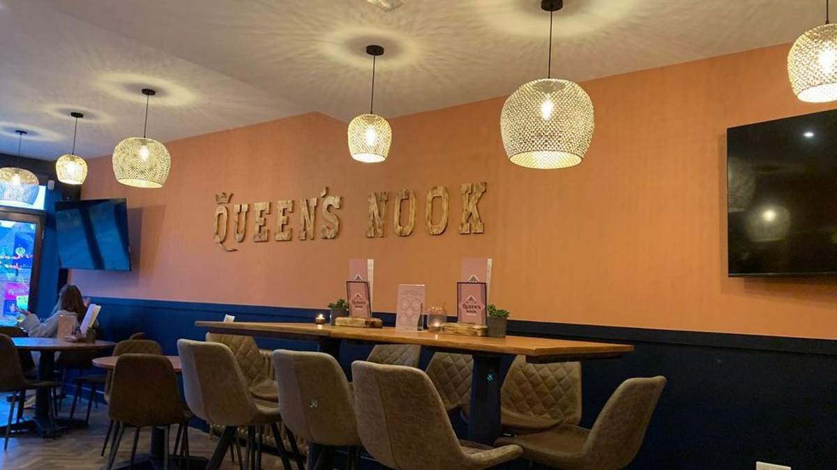The warm peach and navy dining room at The Queen’s Nook