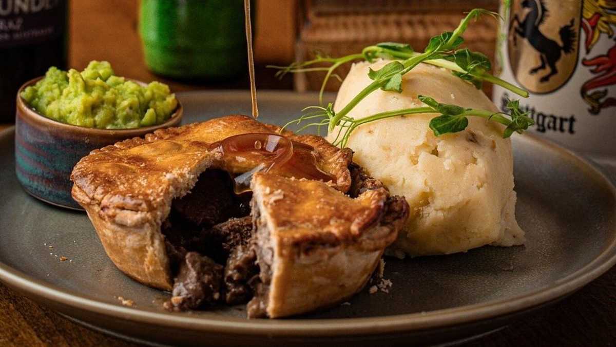 A pie served with mash and vegetables at the Queen’s Nook